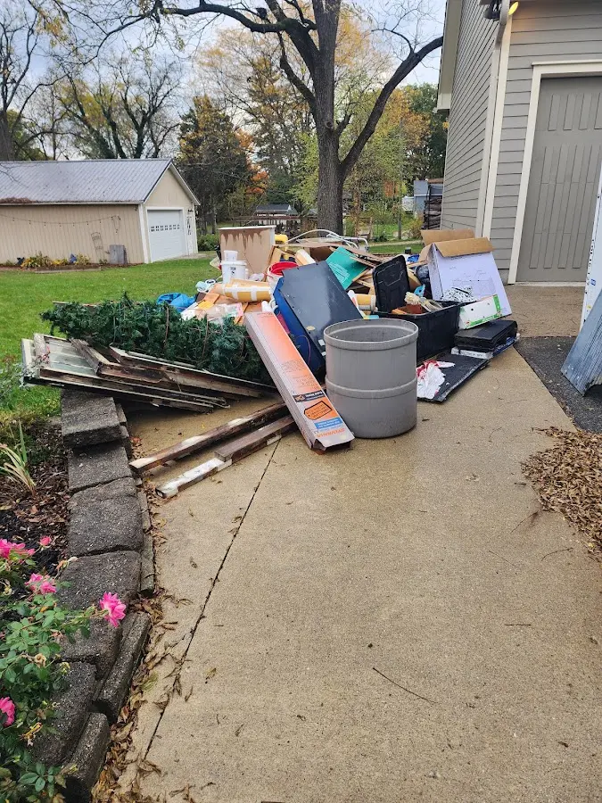 Dumpster being loaded with debris for Roofing Dumpster Rental in Bay Minette
